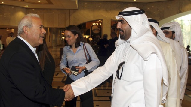 Burhan Ghalioun, leader of the opposition Syrian National Council (SNC), left, shakes hands with one of the attendees during the meeting of the General Assembly of the Syrian National Council in Doha, Qatar, Sunday, November 4, 2012 (photo credit: AP/Osama Faisal)
