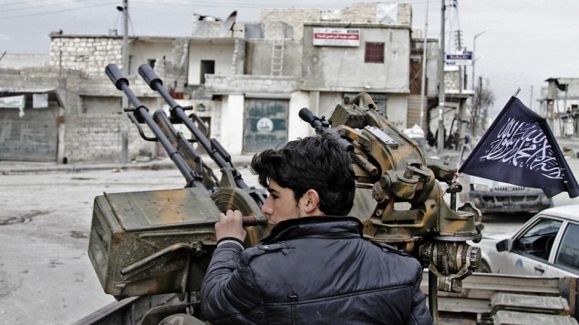 A Free Syrian Army fighter sits behind an anti-aircraft weapon, February 8, 2013. (photo credit: AP/Abdullah al-Yassin)