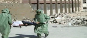 This image, made from a video posted on September 18, 2013, shows Syrians in protective suits and gas masks conducting a drill on how to treat casualties of a chemical weapons attack, in Aleppo, Syria (photo credit: AP)