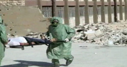 This image, made from a video posted on September 18, 2013, shows Syrians in protective suits and gas masks conducting a drill on how to treat casualties of a chemical weapons attack, in Aleppo, Syria (photo credit: AP)