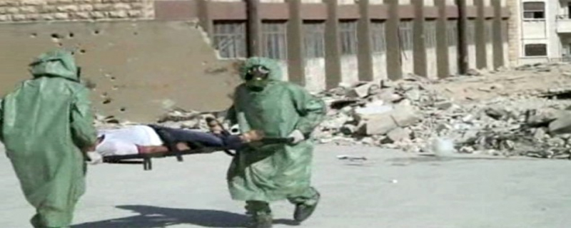 This image, made from a video posted on September 18, 2013, shows Syrians in protective suits and gas masks conducting a drill on how to treat casualties of a chemical weapons attack, in Aleppo, Syria (photo credit: AP)